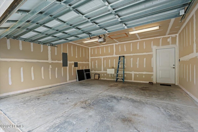 garage featuring a garage door opener and electric panel