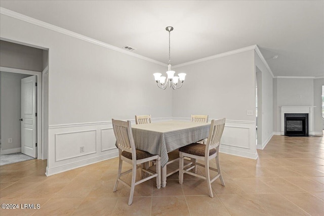 tiled dining area featuring ornamental molding and a chandelier