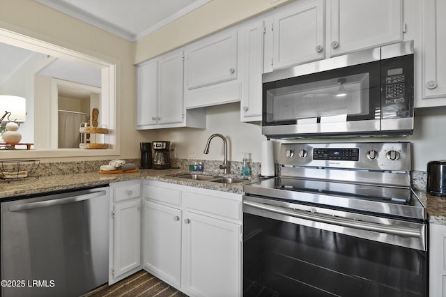 40 Folly Field Rd Unit 340, Hilton Head Island, SC 29928 - kitchen featuring appliances with stainless steel finishes, white cabinetry, ornamental molding, light stone countertops, and dark wood finished floors