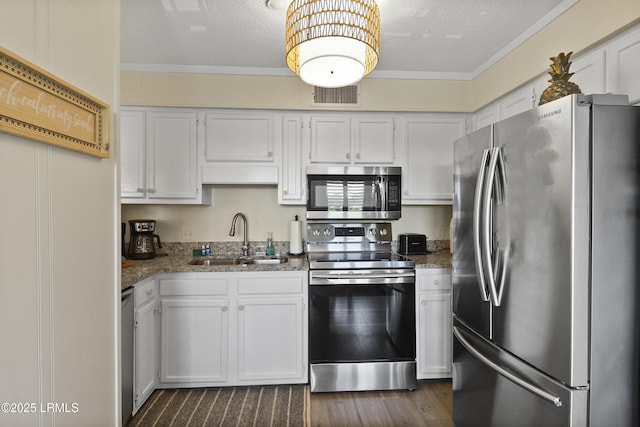 40 Folly Field Rd Unit 340, Hilton Head Island, SC 29928 - kitchen featuring stainless steel appliances, stone countertops, white cabinetry, a textured ceiling, and crown molding