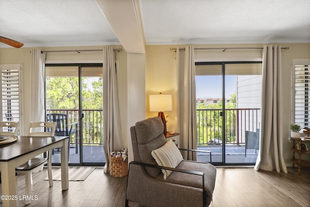 40 Folly Field Rd Unit 340, Hilton Head Island, SC 29928 - sitting room featuring hardwood / wood-style flooring, crown molding, a textured ceiling, healthy amount of natural light, and a ceiling fan