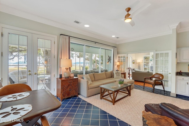 living area with ornamental molding, ceiling fan, french doors, and visible vents