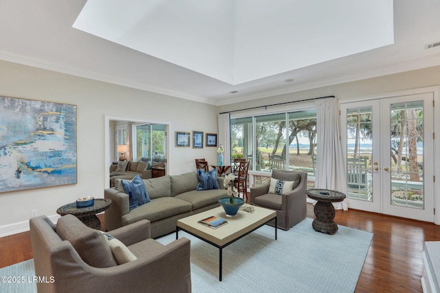 living area featuring french doors, visible vents, crown molding, and wood finished floors