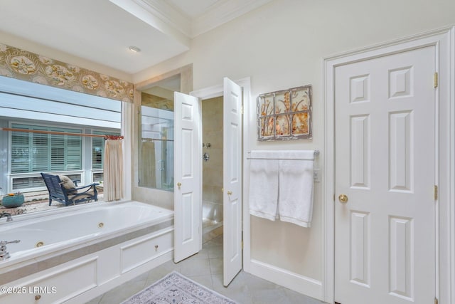 full bath featuring baseboards, crown molding, a tub with jets, and tile patterned floors