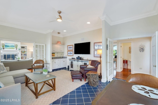 living room with ornamental molding, french doors, and a fireplace