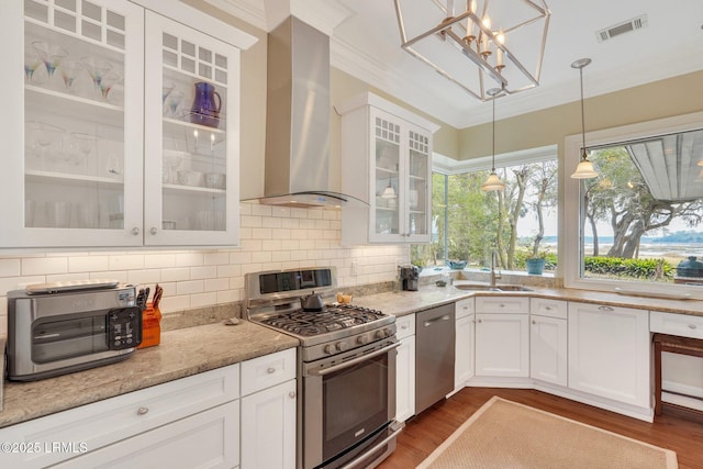 kitchen featuring extractor fan, visible vents, white cabinetry, appliances with stainless steel finishes, and glass insert cabinets