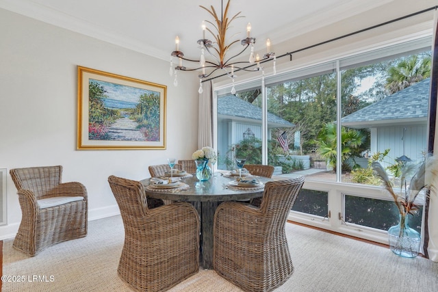 dining room with baseboards, a chandelier, and crown molding