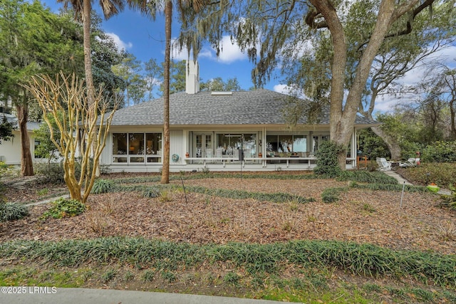 back of property with roof with shingles