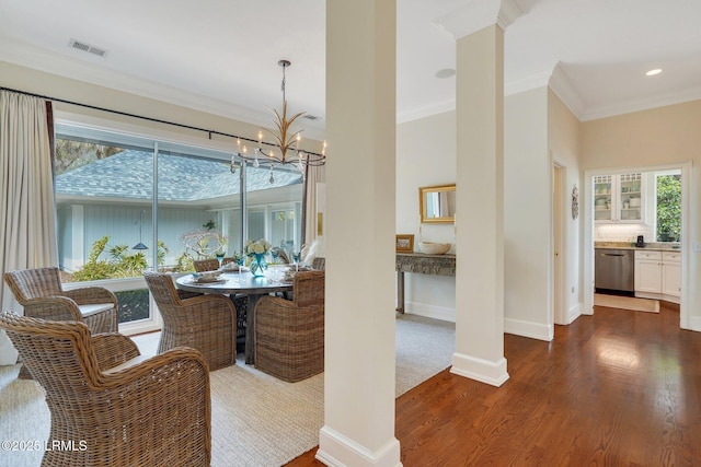 dining room with a chandelier, visible vents, baseboards, ornamental molding, and dark wood-style floors