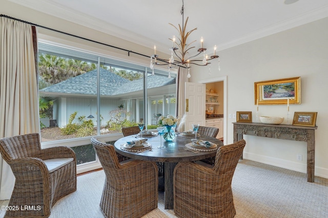 dining space with ornamental molding, baseboards, and an inviting chandelier