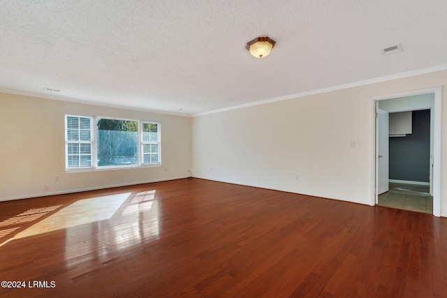 unfurnished room with crown molding, wood-type flooring, and a textured ceiling