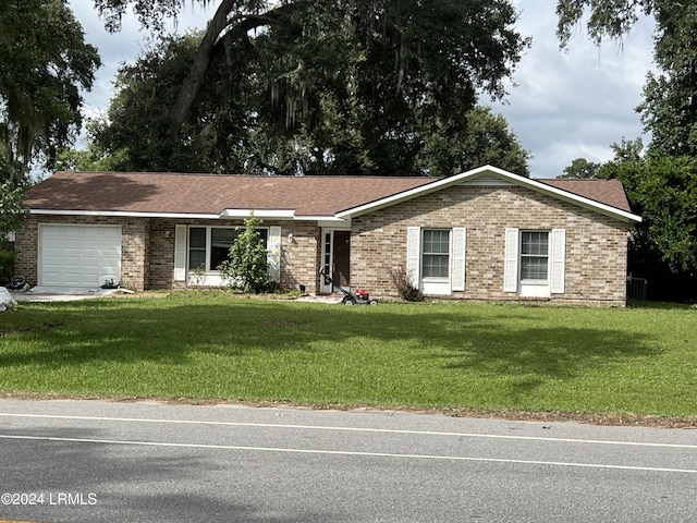 single story home featuring a garage and a front yard