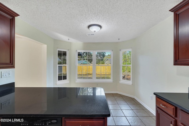 kitchen with dishwasher, a textured ceiling, and light tile patterned flooring