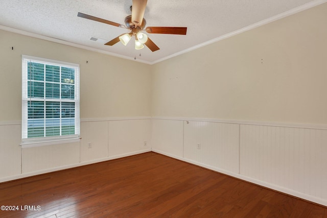 empty room with ornamental molding, hardwood / wood-style floors, ceiling fan, and a textured ceiling