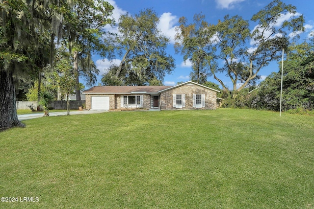 ranch-style house featuring a garage and a front lawn