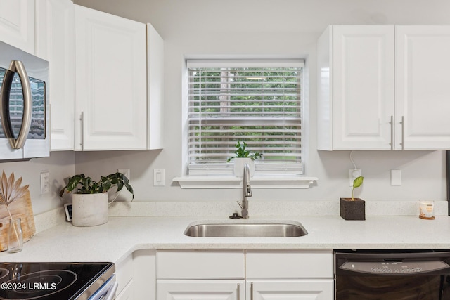 kitchen featuring white cabinetry, dishwasher, and sink