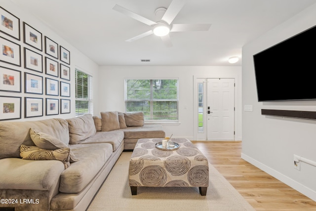 living room featuring light hardwood / wood-style floors and ceiling fan