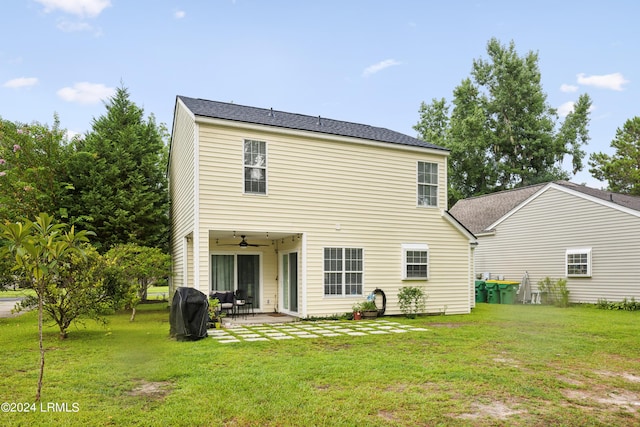 rear view of property featuring a yard, a patio, and ceiling fan