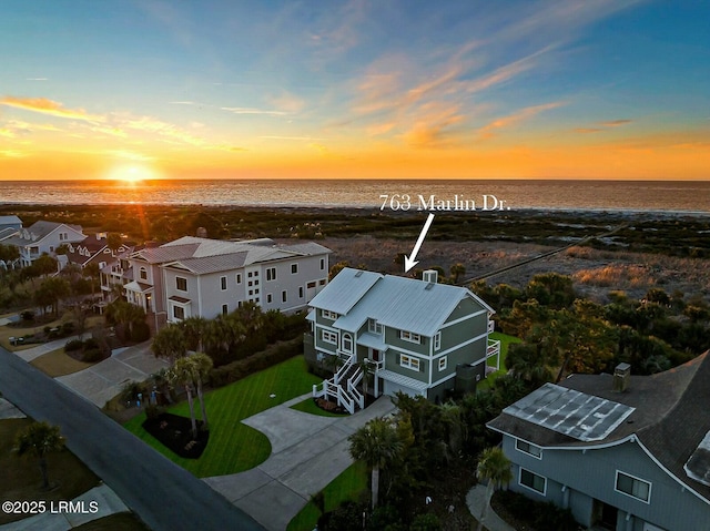 aerial view at dusk with a water view