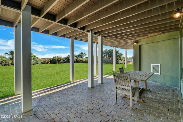 view of patio with outdoor dining area and visible vents