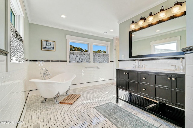 bathroom featuring crown molding, a freestanding bath, and a sink