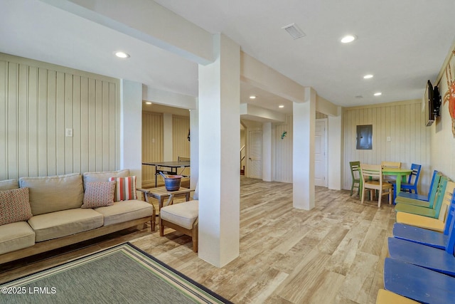 living area with stairway, light wood-type flooring, visible vents, and recessed lighting