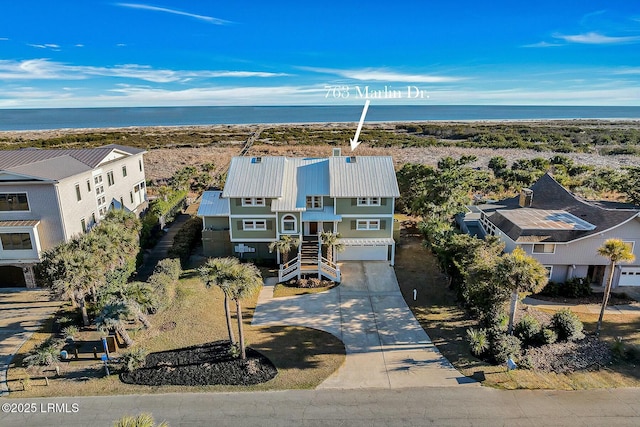 bird's eye view with a water view and a beach view