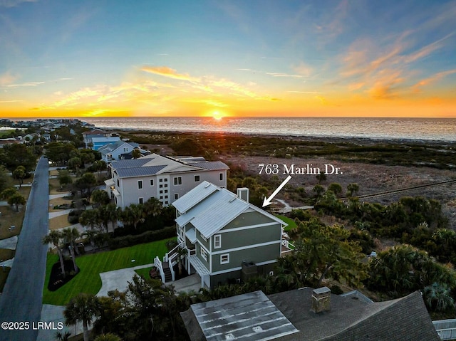 aerial view with a water view and a beach view