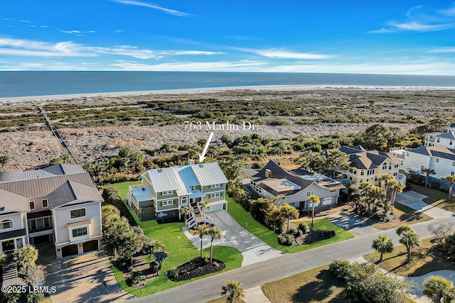 drone / aerial view with a water view and a beach view