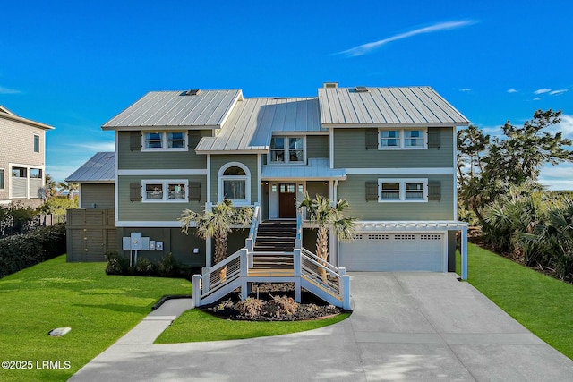 coastal home featuring stairway, metal roof, concrete driveway, and a front yard