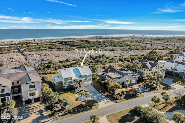 drone / aerial view featuring a water view and a beach view