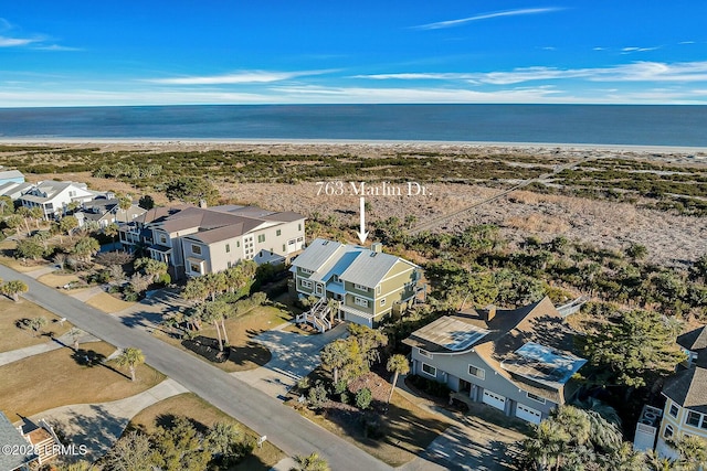 aerial view with a water view and a beach view