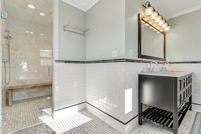 bathroom featuring ornamental molding, a stall shower, wainscoting, and tile walls