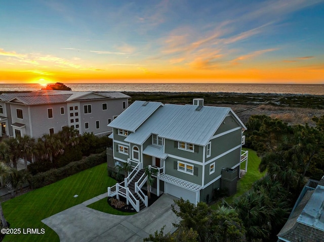 drone / aerial view with a water view and a beach view