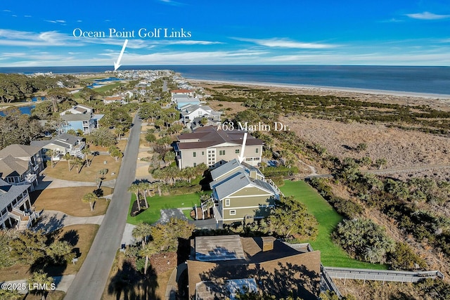 drone / aerial view with a water view and a view of the beach