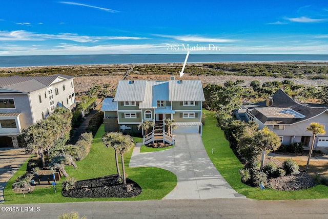 birds eye view of property featuring a water view and a view of the beach