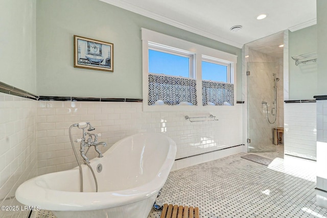 bathroom featuring a freestanding tub, a shower stall, tile walls, and crown molding