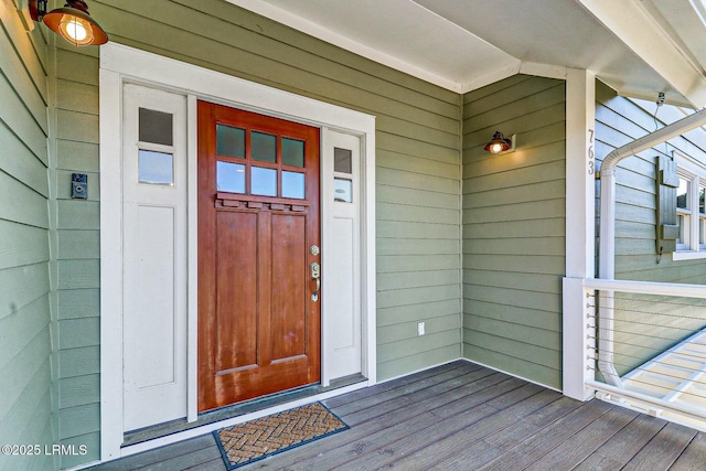 view of exterior entry featuring covered porch