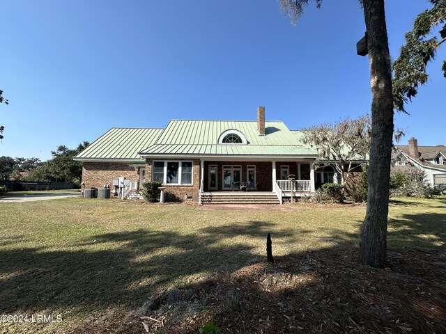 back of house with a yard, central AC, and covered porch