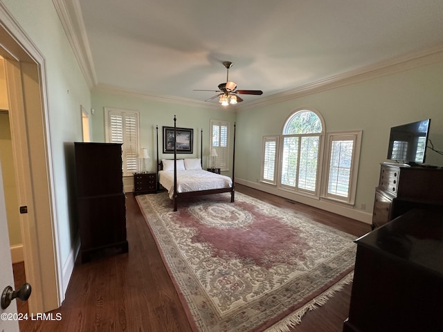 bedroom with crown molding, dark hardwood / wood-style flooring, and ceiling fan