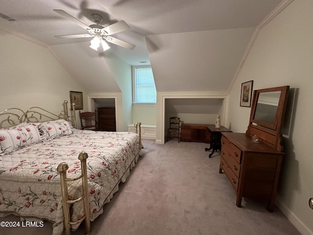 bedroom with crown molding, vaulted ceiling, light colored carpet, and ceiling fan