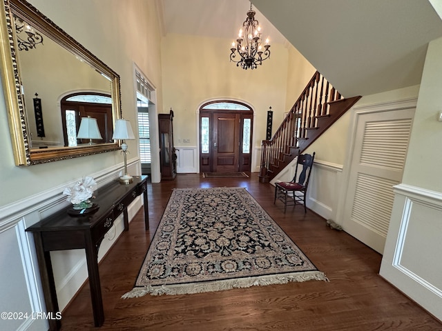 foyer entrance featuring dark wood-type flooring and a notable chandelier