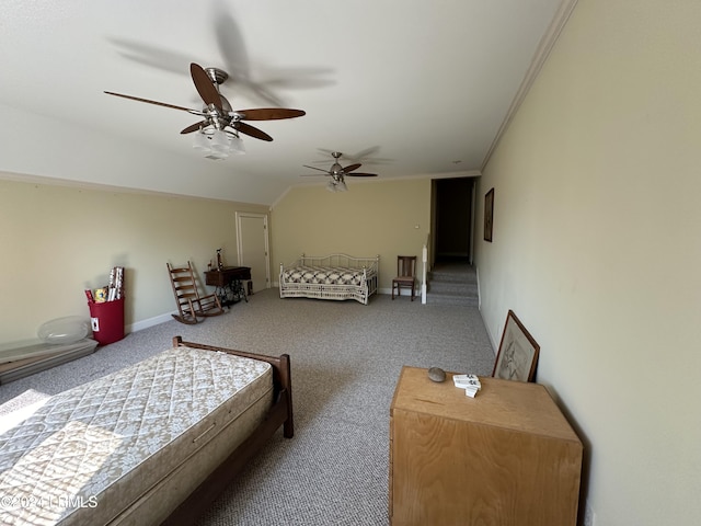 carpeted bedroom with crown molding, vaulted ceiling, and ceiling fan