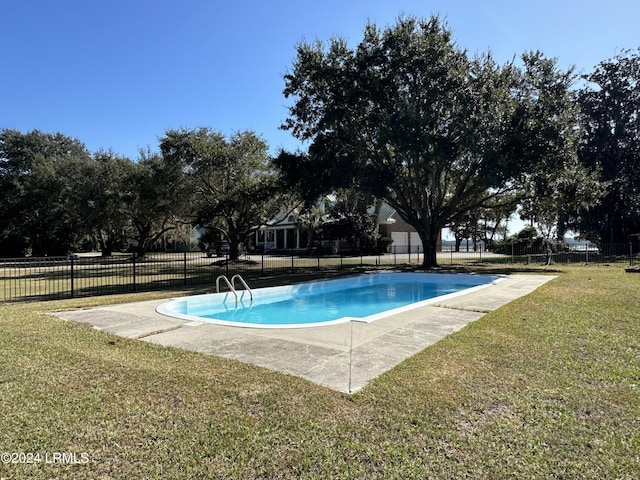 view of pool featuring a lawn