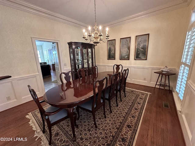 dining room featuring crown molding, dark hardwood / wood-style floors, and a chandelier