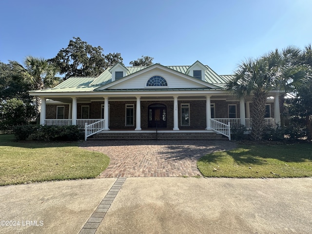 view of front of house featuring a front yard and covered porch