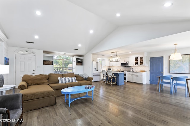 living room with hardwood / wood-style flooring and high vaulted ceiling