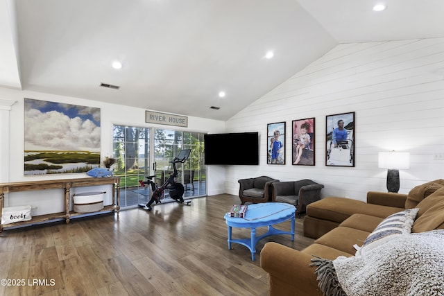 living room featuring hardwood / wood-style flooring and high vaulted ceiling