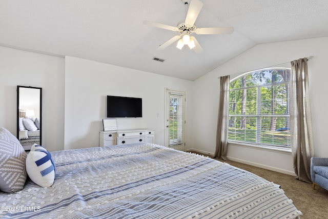 bedroom featuring ceiling fan, carpet flooring, vaulted ceiling, and a textured ceiling