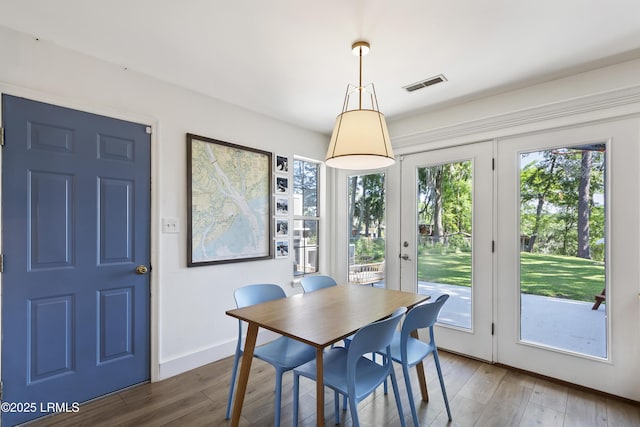 dining space featuring wood-type flooring